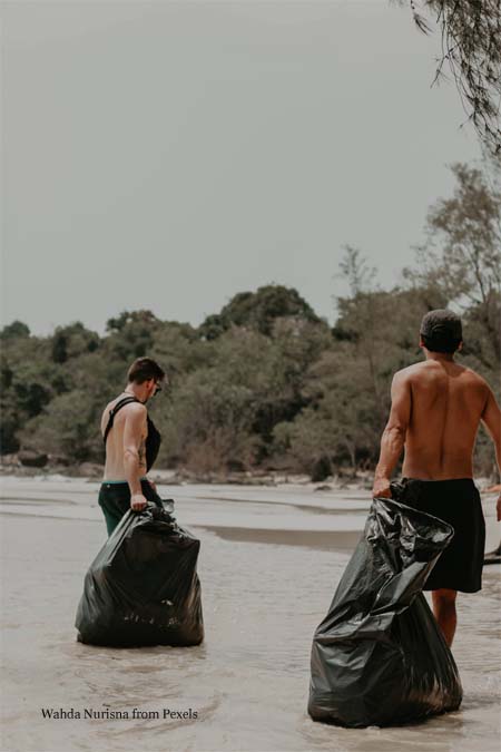 Men With Garbage Bags on Seashore
