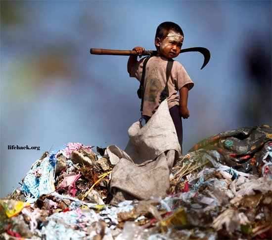 Young child collecting plastic at a rubbish dump in Thailand